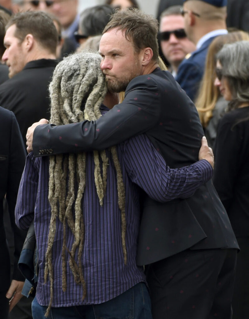 Jeff Ament, of Pearl Jam, hugs a guest at a funeral for Chris Cornell at the Hollywood Forever Cemetery on Friday, May 26, 2017, in Los Angeles. (Photo by Chris Pizzello/Invision/AP) Chris Cornell Funeral